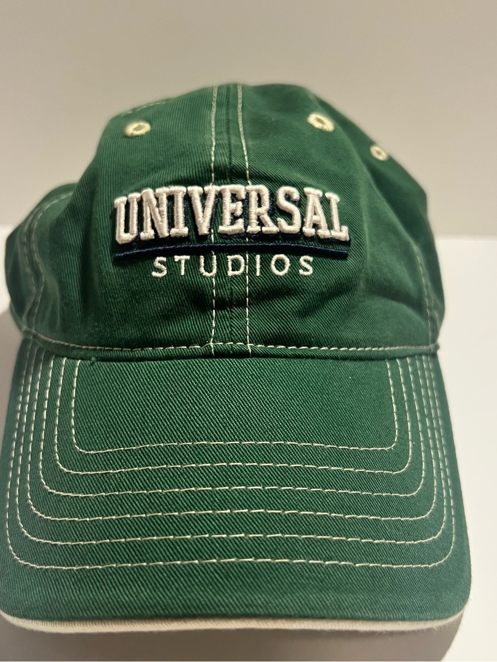 Universal Dark Green Strapback Hat with Teal Patch